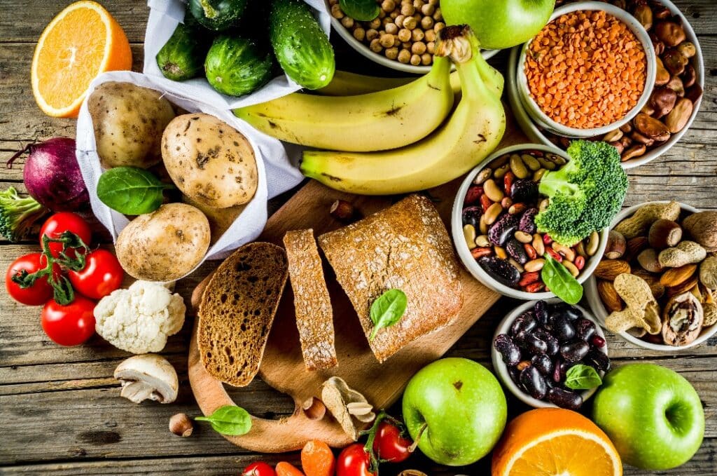 Healthy food. Selection of good carbohydrate sources, high fiber rich food. Low glycemic index diet. Fresh vegetables, fruits, cereals, legumes, nuts, greens.  copy space